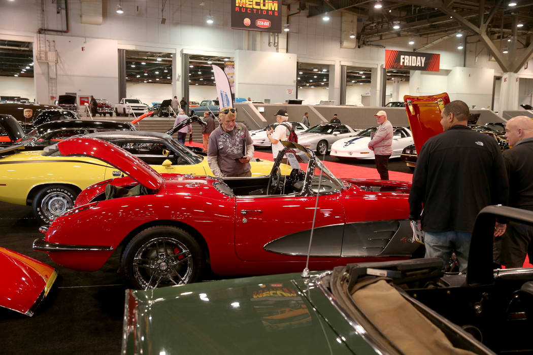 People check out cars during Mecum Las Vegas auction at the Las Vegas Convention Center Thursda ...