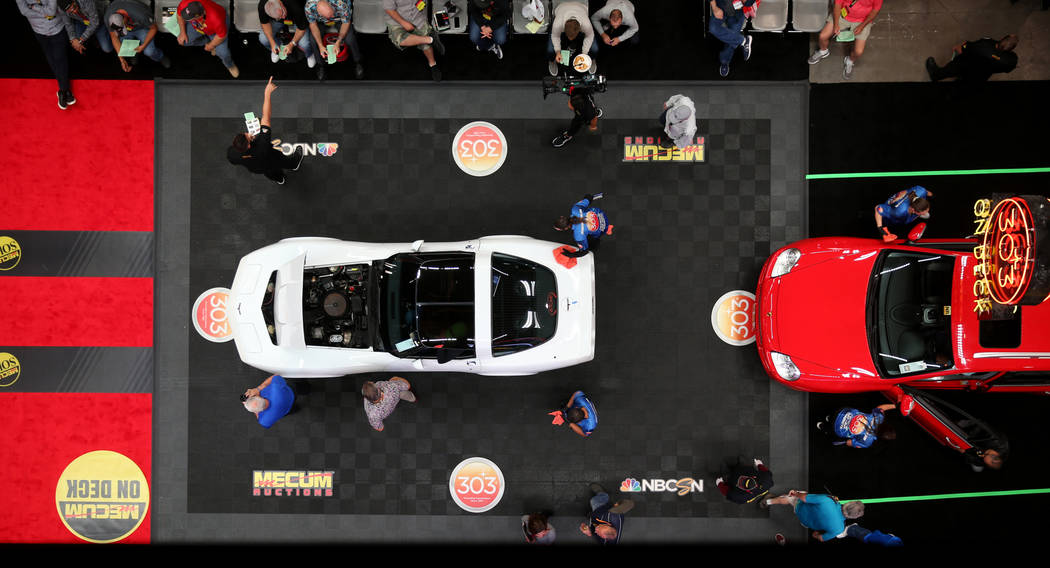 Workers prepare cars for the auction block during Mecum Las Vegas auction at the Las Vegas Conv ...