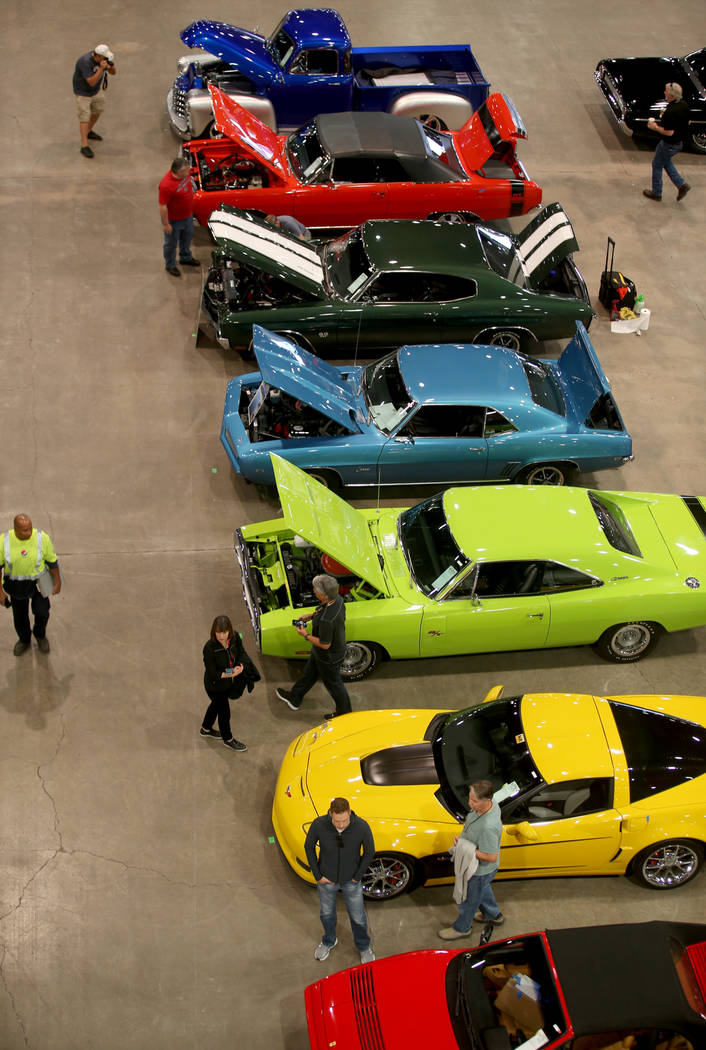 People check out cars during Mecum Las Vegas auction at the Las Vegas Convention Center Thursda ...