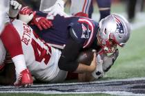 New England Patriot quarterback Tom Brady scores a touchdown in the second half of an NFL footb ...