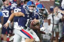 Mississippi quarterback John Rhys Plumlee (10) looks downfield for Vanderbilt defenders he scor ...