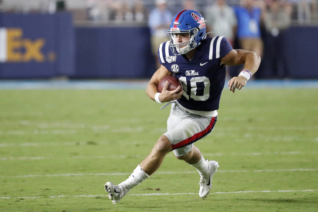 Mississippi quarterback John Rhys Plumlee (10) runs for a first down during the first half of t ...