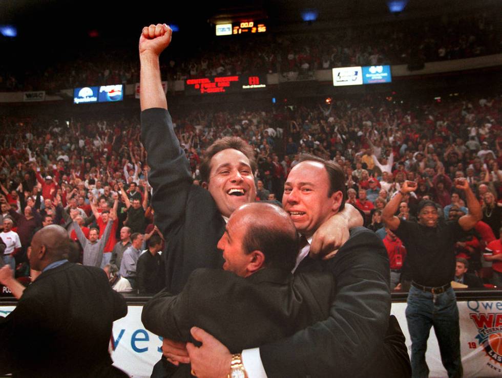 UNLV basketball coach Bill Bayno and his coaching staff celebrate the Rebels 56-51 victory ove ...