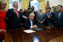 In a Sept. 1, 2017, file photo, religious leaders pray with President Donald Trump after he sig ...