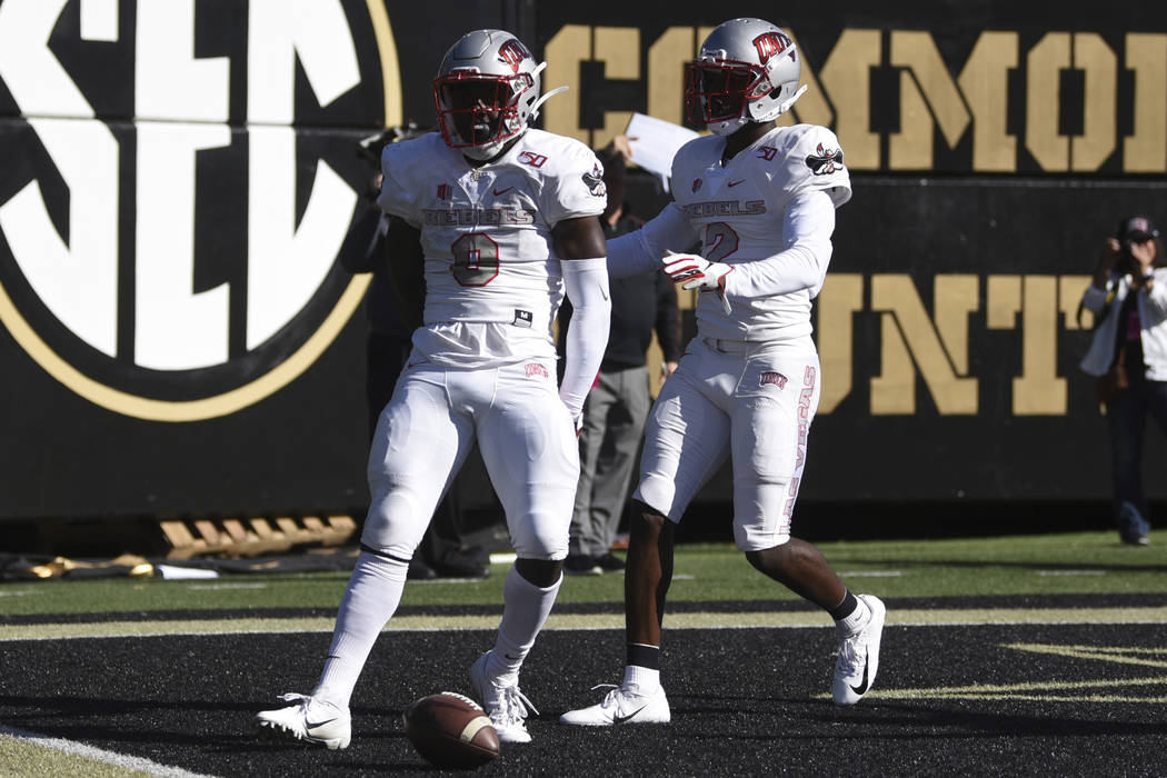 UNLV running back Charles Williams (8) celebrates a touchdown against Vanderbilt along with rec ...