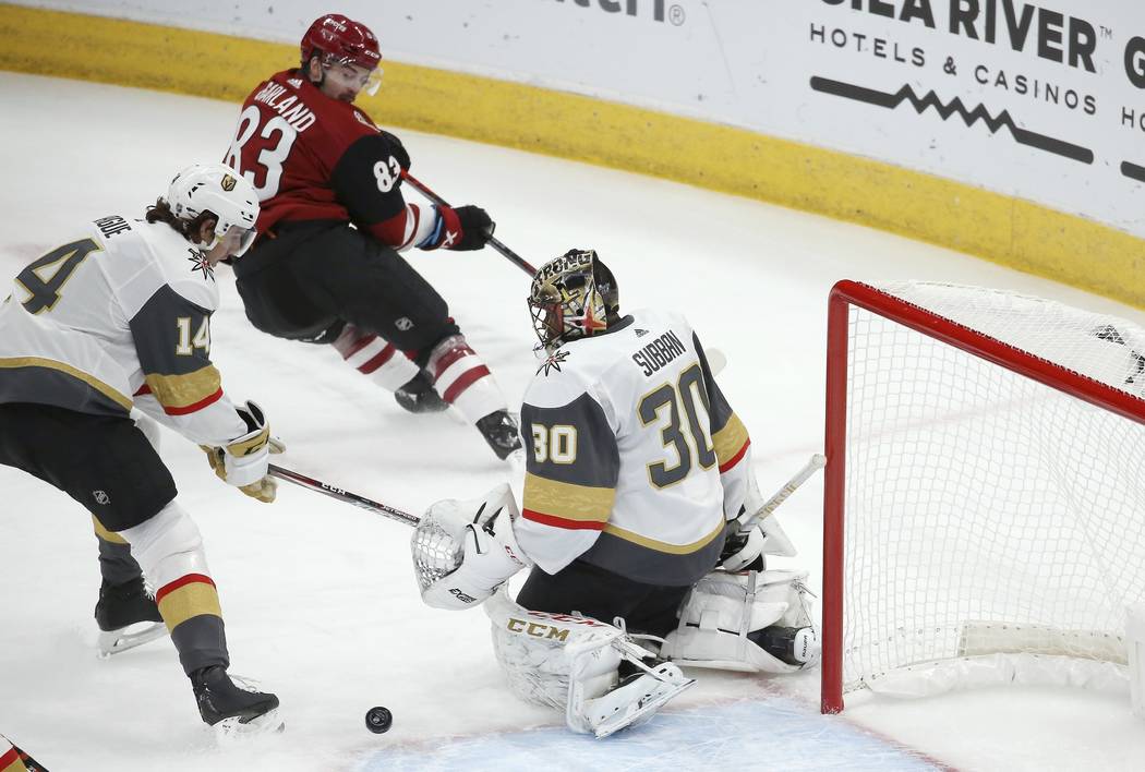 Arizona Coyotes right wing Conor Garland (83) sends the puck past Vegas Golden Knights defensem ...