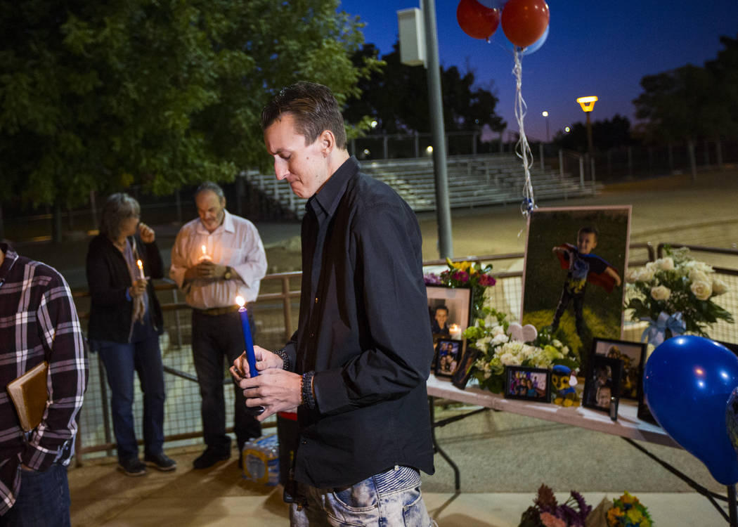 Sean Murray holds a candle while remembering his son, Gavin Murray Palmer, who was lost in a ho ...