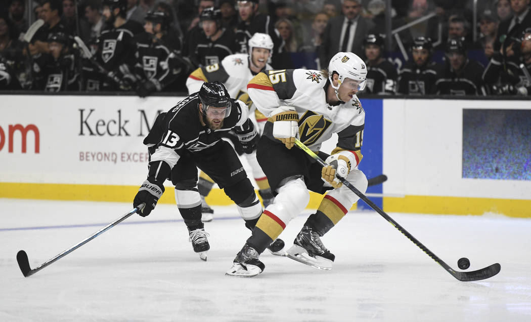 Vegas Golden Knights defenseman Jon Merrill attempts to clear the puck as Los Angeles Kings lef ...