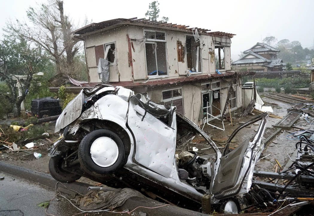 Destroyed house and vehicle are seen following a strong wind in Ichihara, Chiba, near Tokyo Sat ...
