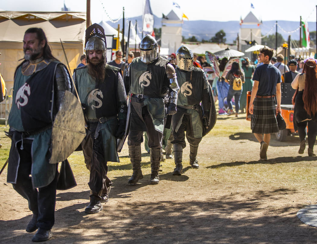 Knights make their way with others up the road about the Royal Court area during the Age of Chi ...