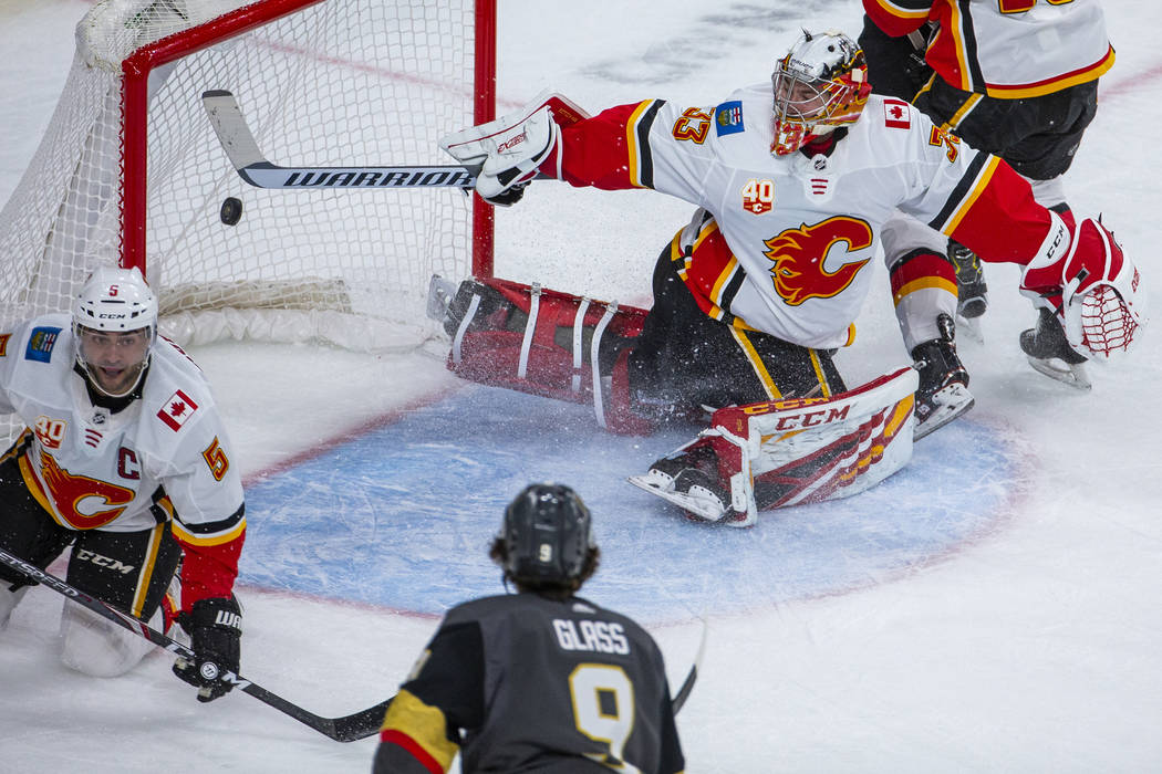 Calgary Flames goaltender David Rittich (33, top) is unable to stop a shot into the net by Vega ...