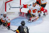 Calgary Flames goaltender David Rittich (33, top) is unable to stop a shot into the net by Vega ...