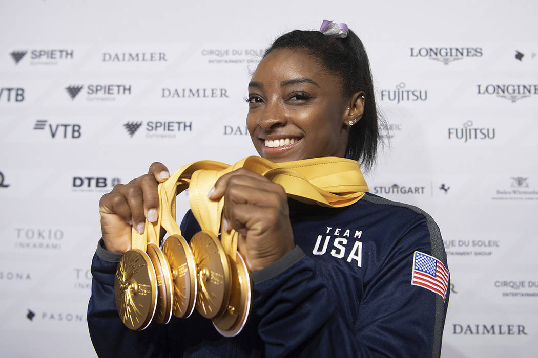 Simone Biles of the United States shows her five gold medals at the Gymnastics World Championsh ...