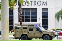 An armored police vehicle enters the Town Center at Boca Raton parking lot in front of Nordstro ...