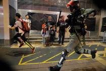 Police chase a protester in Hong Kong, Sunday, Oct.13, 2019. Protesters changed tactics and pop ...