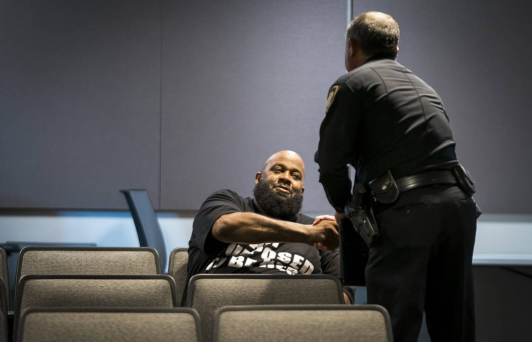 Fort Worth Police Lt. Brandon O'Neil shakes hands with Roger Foggle after addressing a news con ...