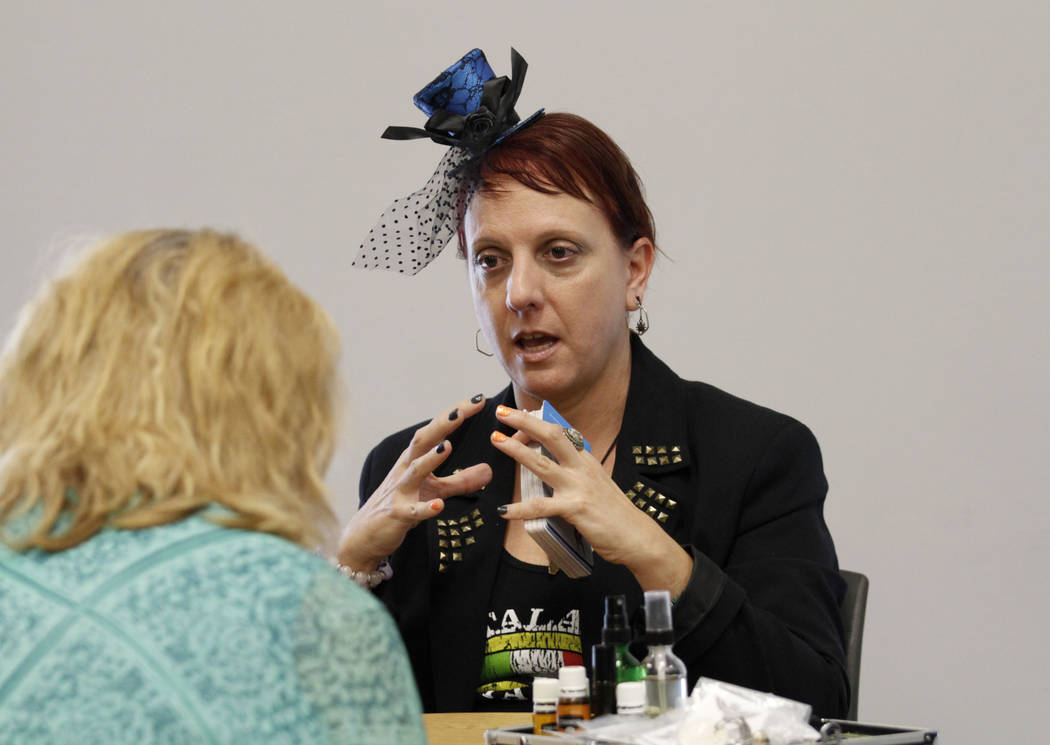 Local psychic Nicole Borghi talks with her client during Mystic Fair at Windmill Library in Las ...