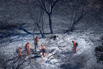 Firefighters put out hot spots in the Porter Ranch area of Los Angeles on Saturday, Oct. 12, 20 ...