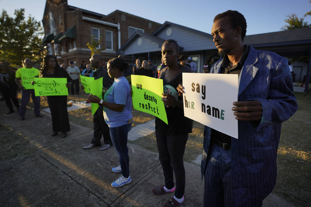 Protesters gather outside the house, right, where Atatiana Jefferson was shot Saturday and kill ...