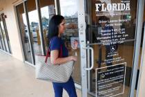 A woman enters a Florida Highway Safety and Motor Vehicles drivers license service center on Tu ...