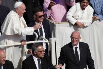 Vatican head of security Domenico Giani, right, flanks Pope Francis' pope mobile at the end of ...