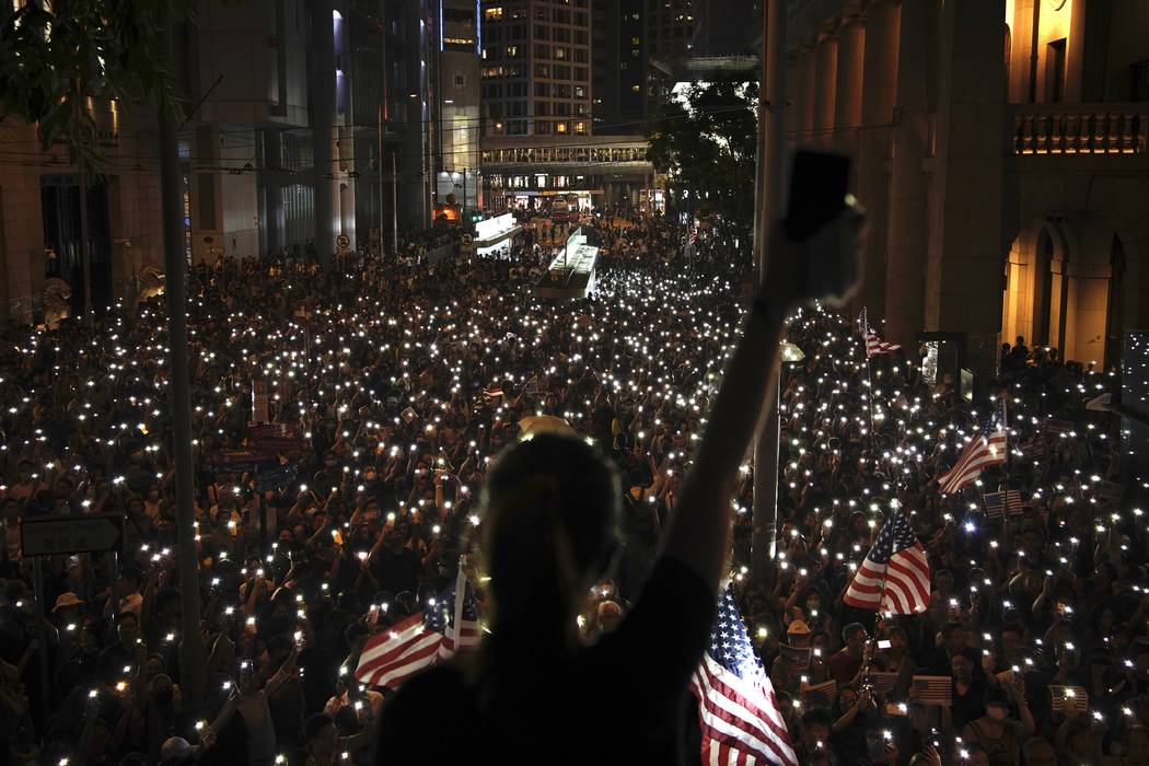 Protestors light their torches during a peaceful rally in central Hong Kong's business district ...