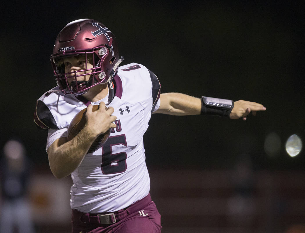 Faith Lutheran junior quarterback Grant Wood (6) scrambles down the sideline during the first q ...