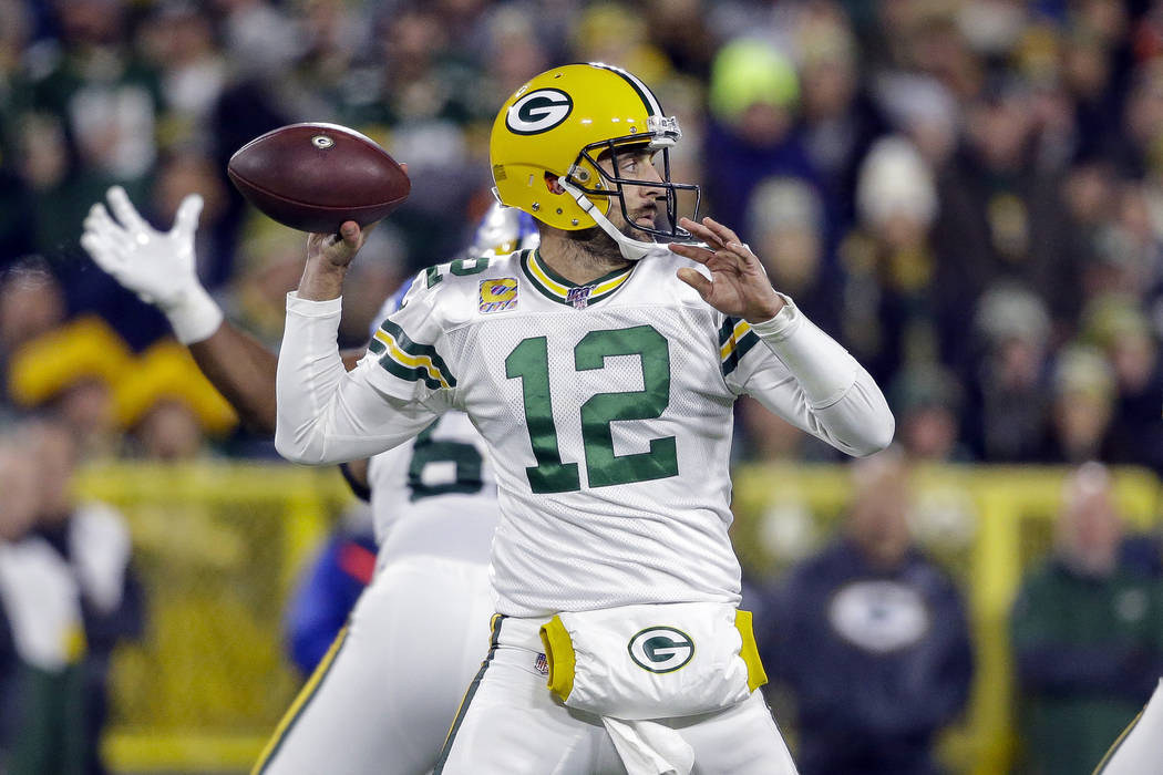 Green Bay Packers quarterback Aaron Rodgers drops back to pass during the first half of an NFL ...