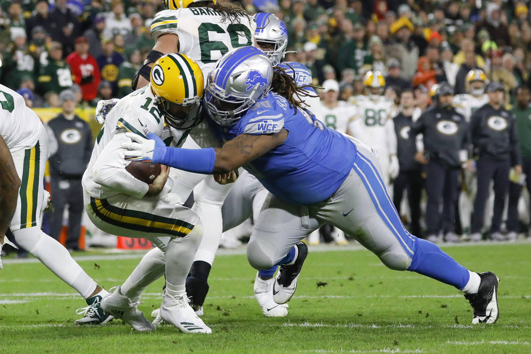 Green Bay Packers quarterback Aaron Rodgers (12) is sacked by Detroit Lions defensive tackle Da ...