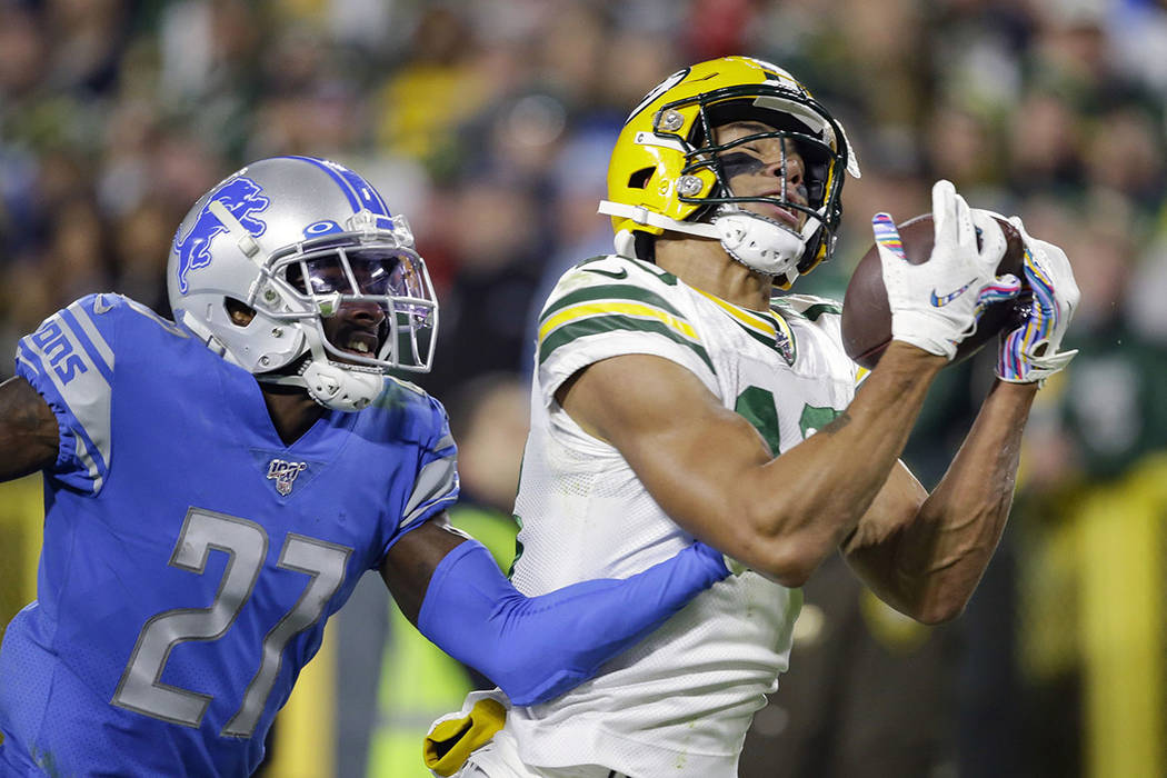 Green Bay Packers wide receiver Allen Lazard, right, catches a pass for a touchdown while cover ...