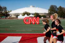 Student athletes pass a CNN sign on an athletic field outside the Clements Recreation Center on ...