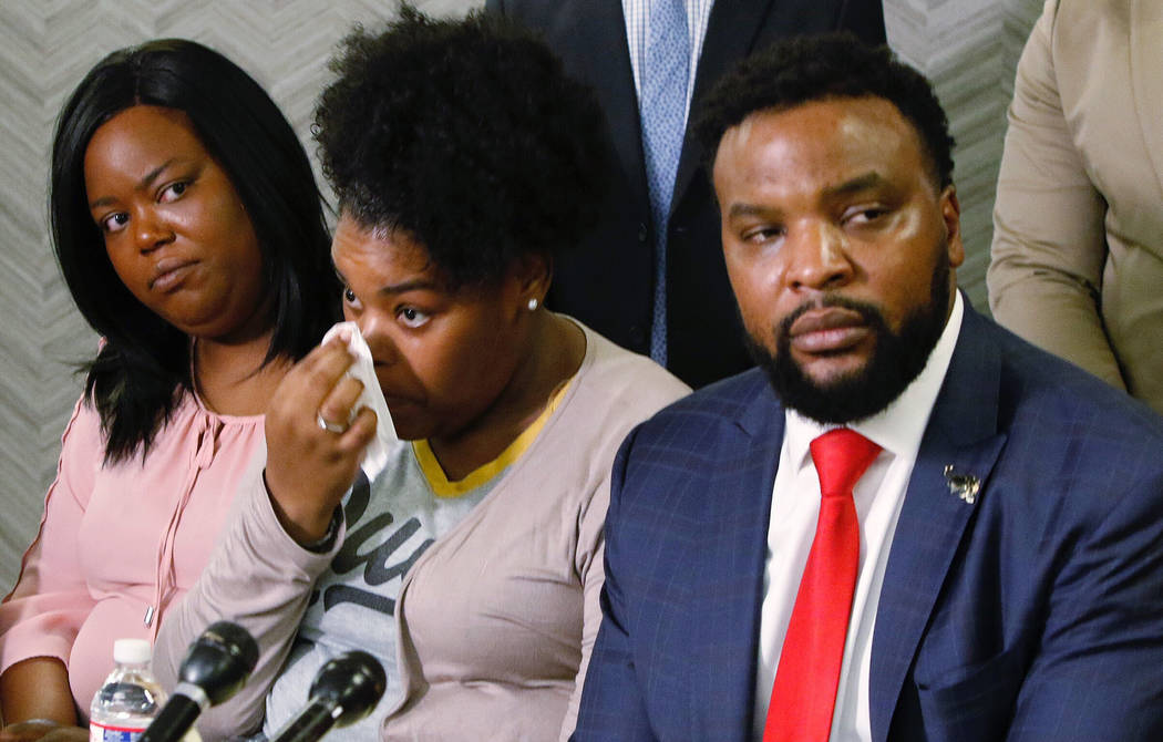 Amber Carr, center, wipes a tear as her sister, Ashley Carr, left, and attorney  Lee Merritt, ri … | Las Vegas Review-Journal