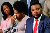 Amber Carr, center, wipes a tear as her sister, Ashley Carr, left, and attorney Lee Merritt, ri ...
