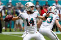 In this Sept. 15, 2019, file photo, Miami Dolphins quarterback Ryan Fitzpatrick (14) looks to p ...