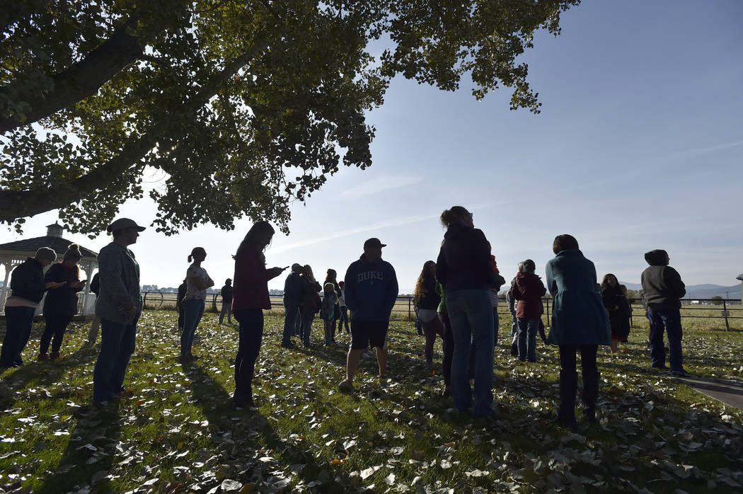 Parents wait for their evacuated students after an improvised explosive device detonated on the ...