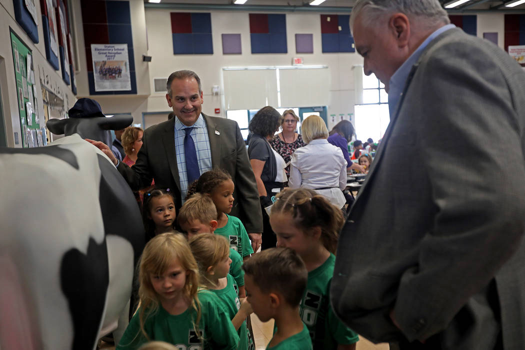 Clark County School District Superintendent Jesus Jara, center, laughs with Gov. Steve Sisolak, ...