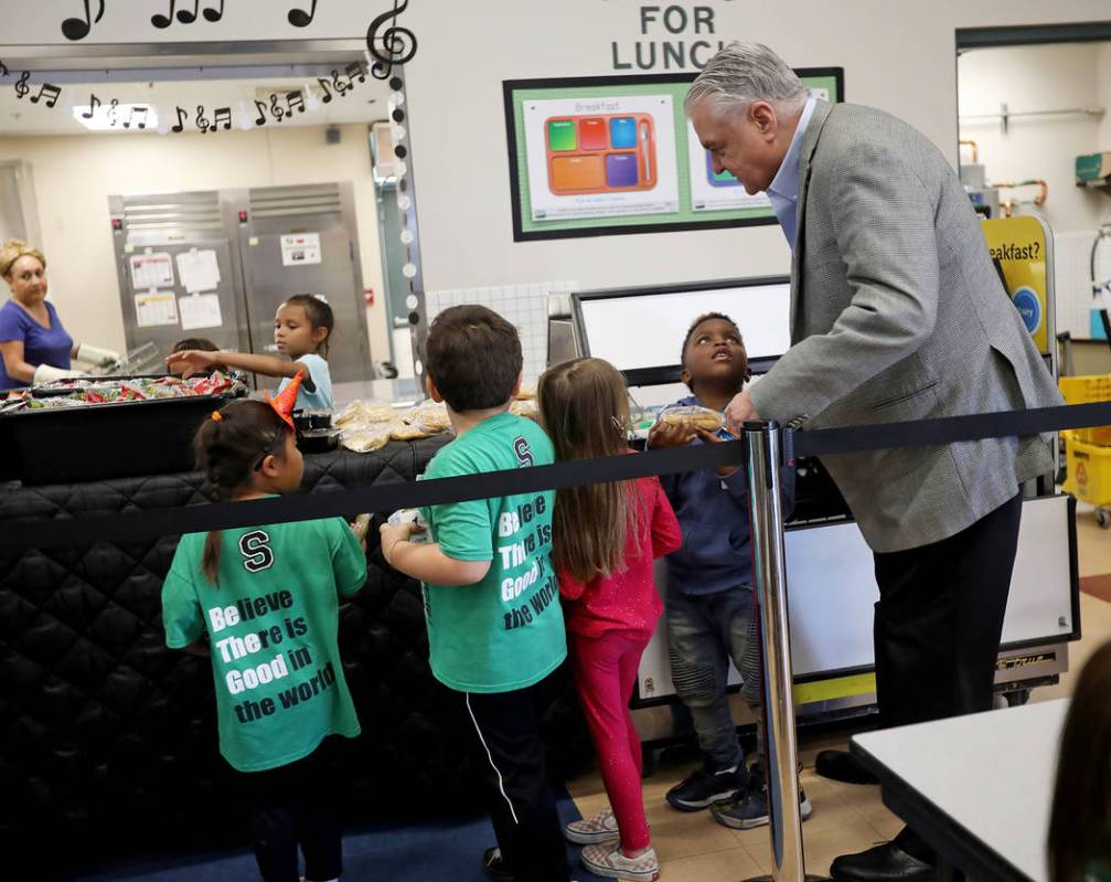 Gov. Steve Sisolak talks to student Samar Sims, 5, in the lunch line at Staton Elementary Schoo ...