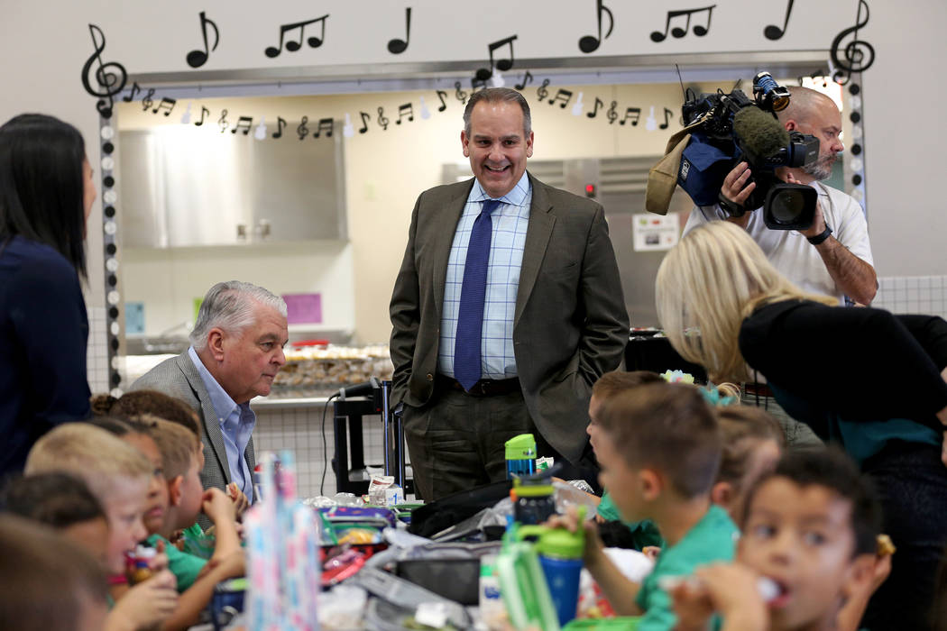 Clark County School District Superintendent Jesus Jara, center, speaks to students as Gov. Stev ...