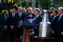 President Donald Trump is presented a team jersey by St. Louis Blues owner Tom Stillman during ...