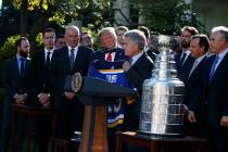 President Donald Trump is presented a team jersey by St. Louis Blues owner Tom Stillman during ...