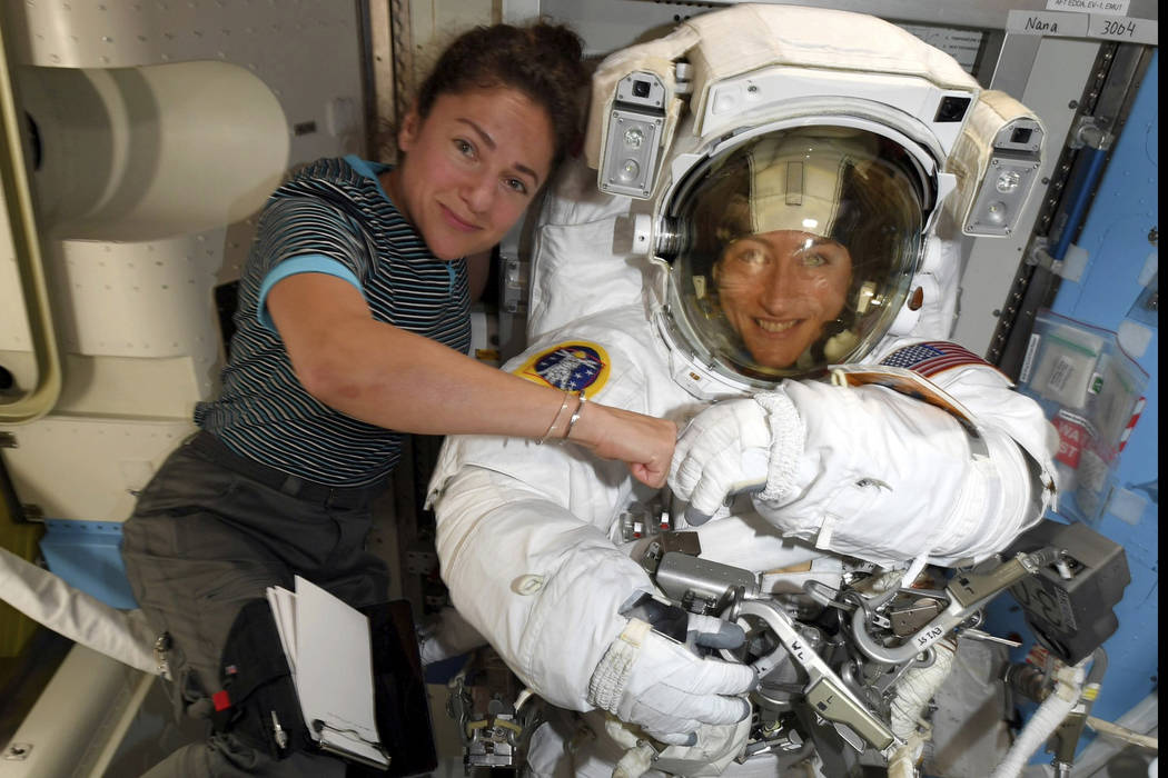 FILE - In this image released Friday, Oct. 4, 2019, by NASA, astronauts Christina Koch, right, ...