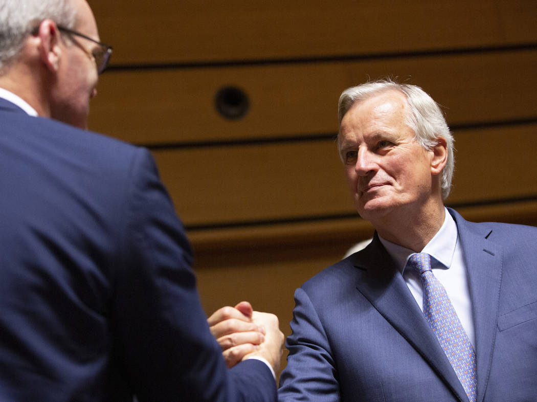European Union chief Brexit negotiator Michel Barnier, right, shakes hands with Irish Foreign M ...