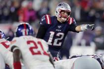 New England Patriots quarterback Tom Brady calls signals at the line of scrimmage in the first ...