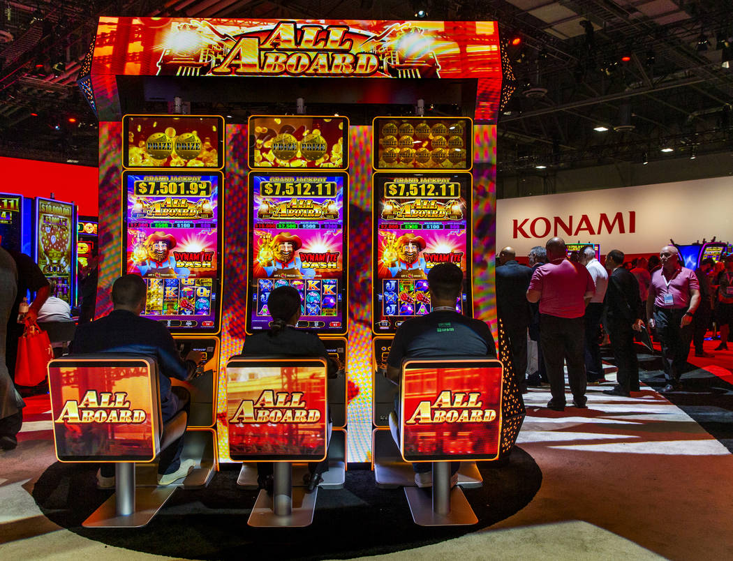 Attendees play the new Lucky Dynamite game by Konami Gaming during the Global Gaming Expo 2019 ...
