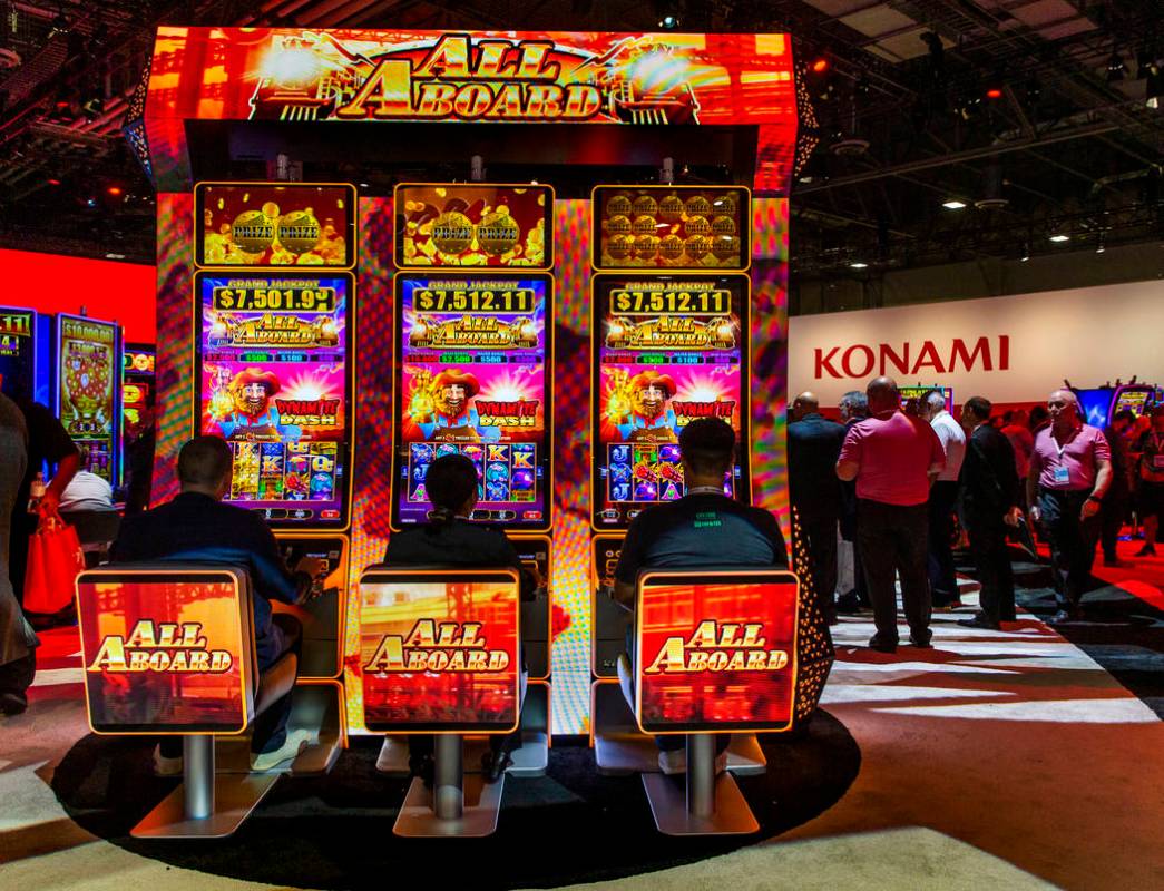 Attendees play the new Lucky Dynamite game by Konami Gaming during the Global Gaming Expo 2019 ...