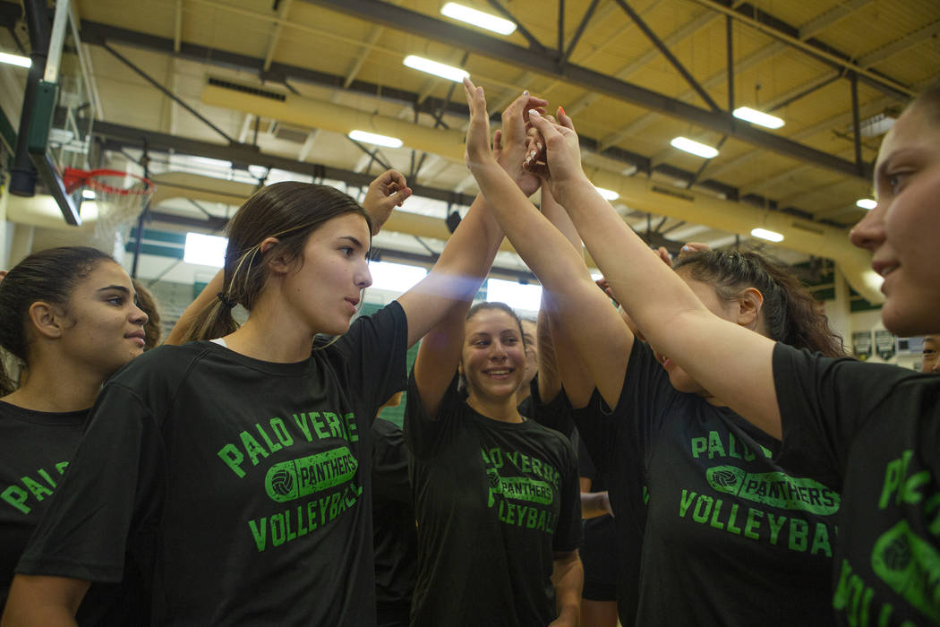 The varsity volleyball team go in for a huddle before a break during volleyball practice at Pal ...