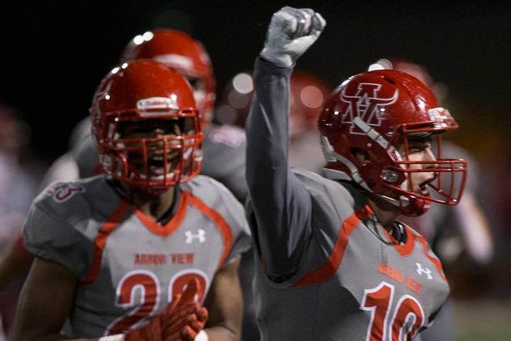 Arbor View senior defensive back Nolan Weir (19) celebrates with teammates after a big defensiv ...