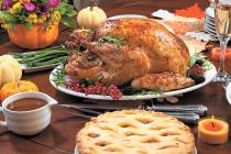 Roasted pepper turkey for Thanksgiving, garnished with pink pepper, blackberry, and fresh rosem ...