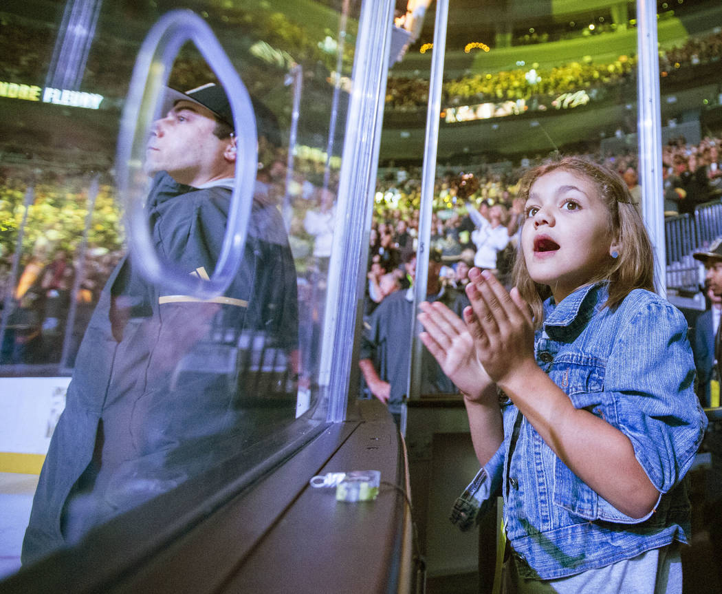 A Golden Knights fan cheers during the first period of Vegas' NHL hockey game with the Nashvill ...