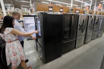 In a Sept. 23, 2019, photo, shoppers examine refrigerators at a Home Depot store in Boston. On ...